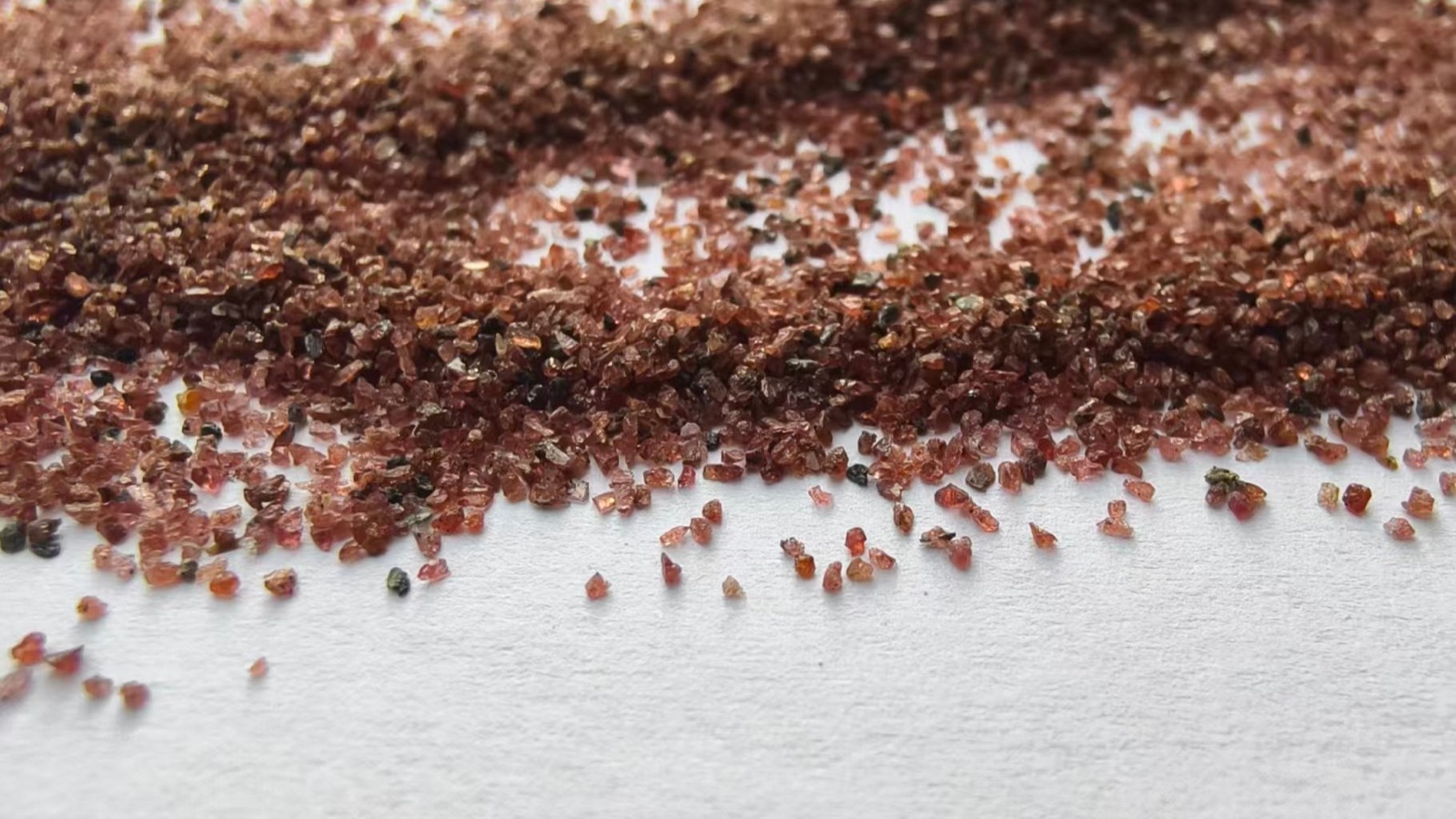 Red garnet abrasive grains, close-up